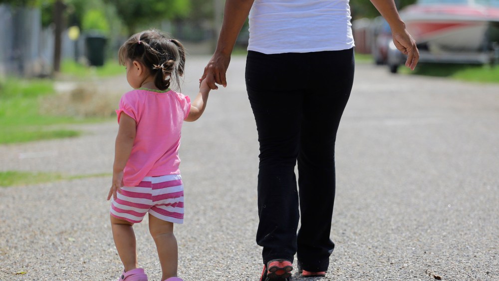 A woman who is in the country illegally walks with her two-year-old daughter who was born in the in the United States but was denied a birth certificate, Sullivan City, Texas, Sep. 16, 2015. (Photo by Eric Gay/AP)
