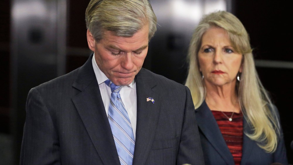 Former Virginia Gov. Bob McDonnell pauses while making a statement as his wife, Maureen, right, listens during a news conference in Richmond, Va., Jan. 21, 2014.