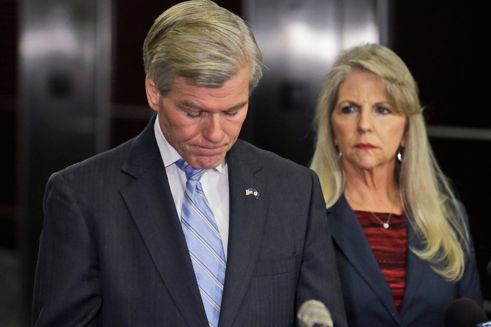 Former Virginia Gov. Bob McDonnell pauses while making a statement as his wife, Maureen, right, listens during a news conference in Richmond, Va., Jan. 21, 2014.