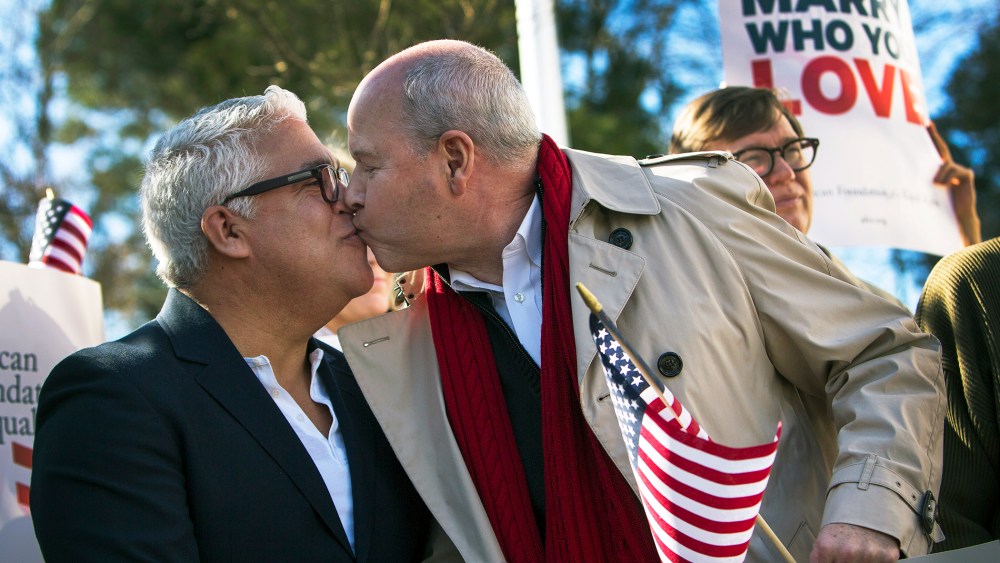 Robert Roman and Claus Ihlemann, of Virginia Beach, celebrate Thursday's ruling that Virginia's same-sex marriage ban was unconstitutional, Feb. 14, 2014, in Norfolk, Va.