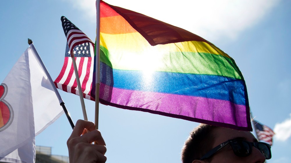 Same-sex marriage supporters rally in front of the Supreme Court.