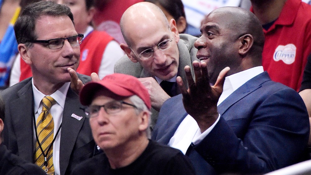 NBA Commissioner Adam Silver talks with Magic Johnson as the Los Angeles Clippers play the Oklahoma City Thunder, May 11, 2014.