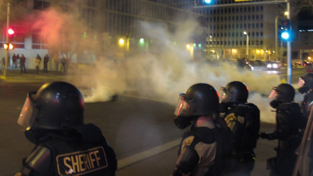 Riot police launch tear gas toward activists in downtown Albuquerque, N.M. following a 10-hour protest around the city, on March 30, 2014.