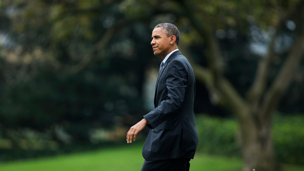 President Barack Obama walks on the South Lawn as he leaves the White House in Washington, Wednesday, Oct. 30, 2013, for a trip to Boston.