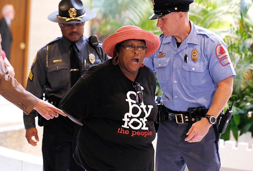 Demonstrators are arrested during "Moral Monday" demonstrations at the North Carolina Legislative Building in Raleigh, N.C., Monday, July 22, 2013. (Photo by Ethan Hyman/The News & Observer/AP)