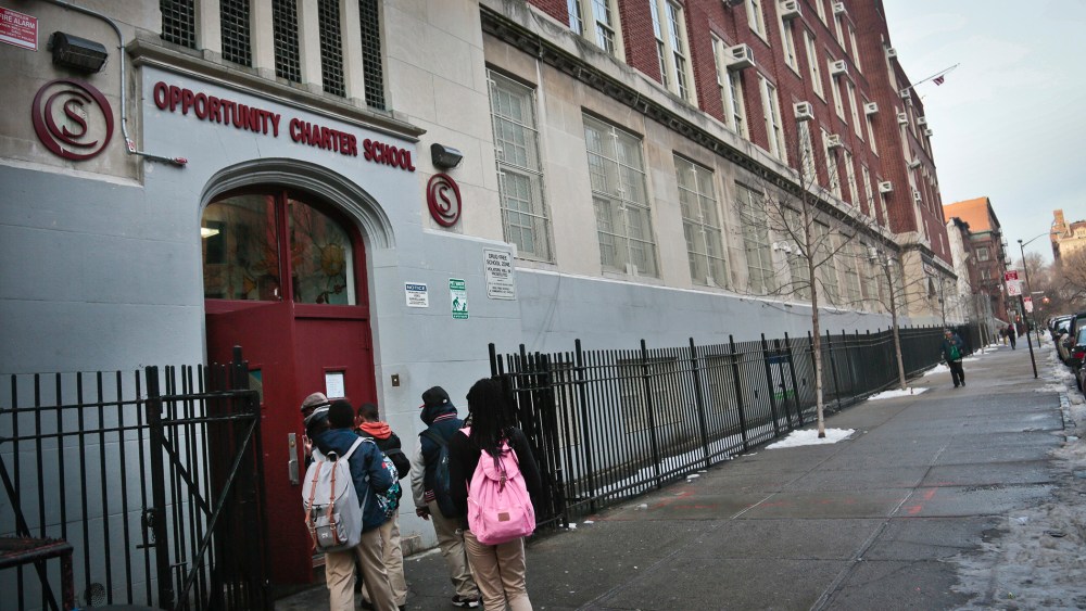 Students use the entrance for Success Academy and Opportunity Charity schools, both of which share space inside Harlem's P.S. 241, in New York on Dec. 20, 2013.