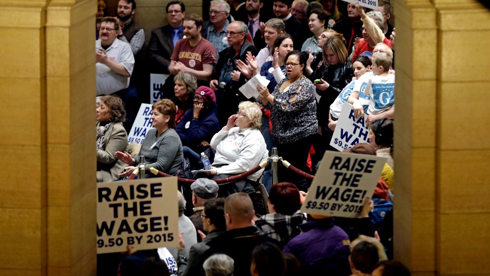 Demonstrators rally at the Minnesota State Capitol in favor of raising the minimum wage on Feb. 25, 2014, in St. Paul, Minn.