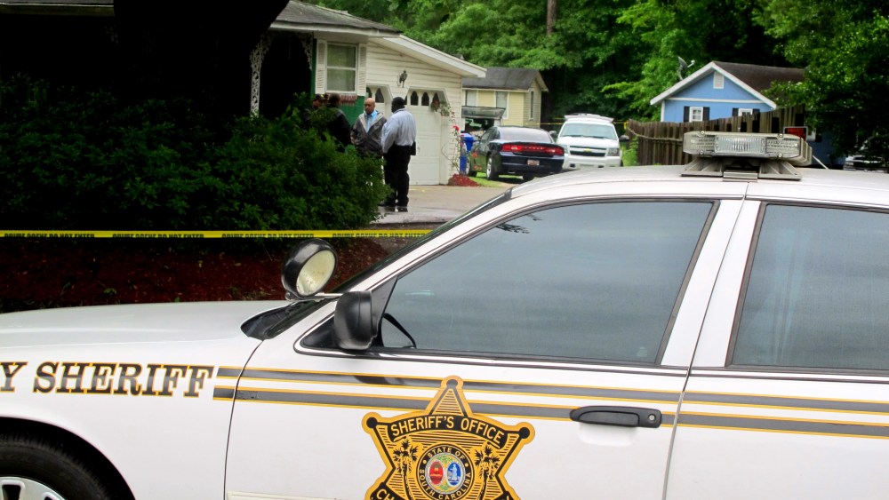 Investigators work at a scene of a shooting in Hollywood, S.C., May 7, 2015. A sheriff's deputy responding to a home invasion shot the homeowner in the neck Thursday because he refused to drop his gun, authorities said. (Photo by Bruce Smith/AP)