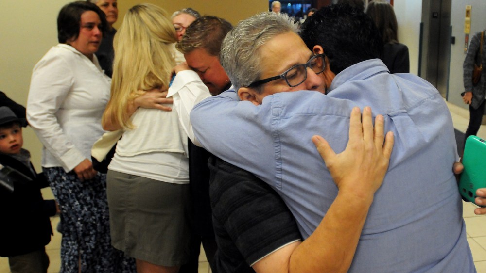 Jody May-Chang hugs her wife Maria May-Chang in the Ada County Courthouse Wednesday morning after copuples were denied a marriage license on Oct. 8, 2014 in Boise, Idaho. (Photo by Adam Eschbach/The Idaho Press-Tribune/AP)