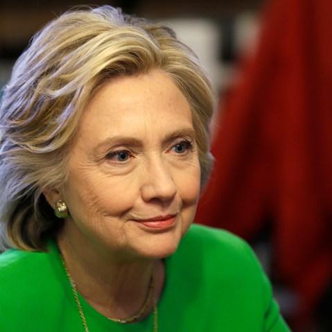 In this April 14, 2015, photo, Democratic presidential candidate Hillary Rodham Clinton meets with local residents at the Jones St. Java House in LeClaire, Iowa. (Photo by Charlie Neibergall/AP)