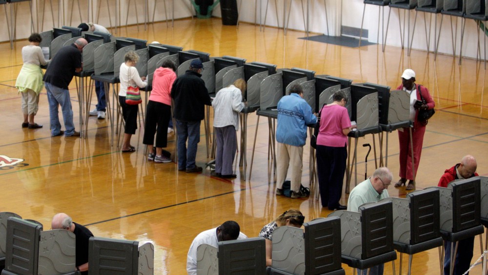 File Photo: Voters cast their ballots at the Herbert Young Community Center polling place in Cary, N.C.. on Thursday, Oct. 18, 2012, the first day of early voting in North Carolina. (Photo by Shawn Rocco/The News & Observer/AP Photo, File)