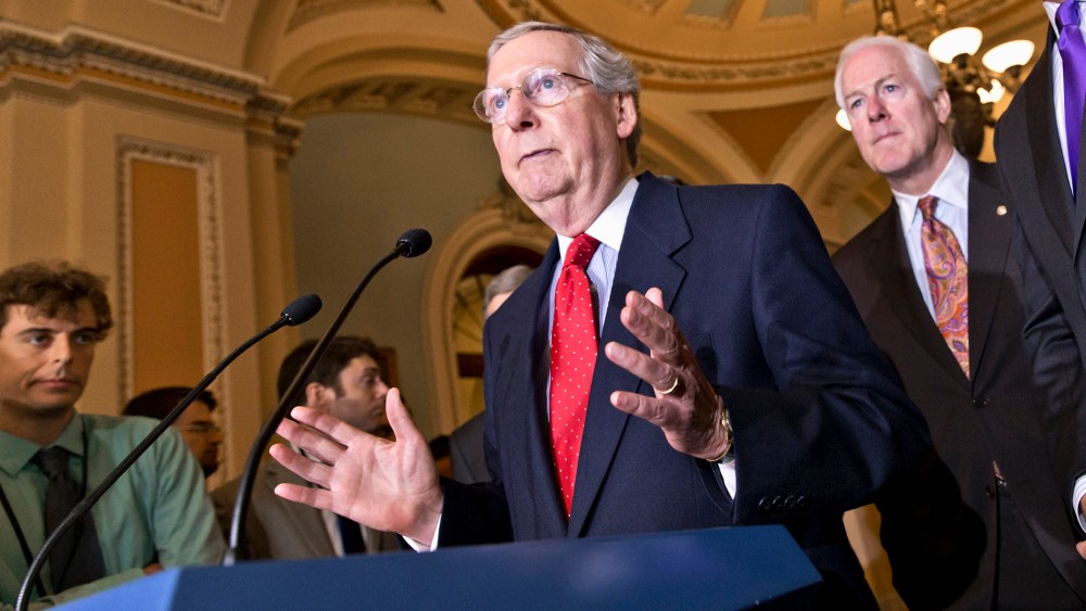 Senate Minority Leader Mitch McConnell of Ky., left, accompanied by Senate Minority Whip John Cornyn of Texas, center, and Sen. John Thune, R-S.D., Senate Republican Conference chairman, talks about the startup problems of the Affordable Care Act as they