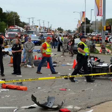 Emergency personnel respond after a vehicle crashed into a crowd of spectators during the Oklahoma State University homecoming parade, causing multiple injuries, Oct. 24, 2015 in Stillwater, Oka. (Photo by David Bitton/The News Press/AP)
