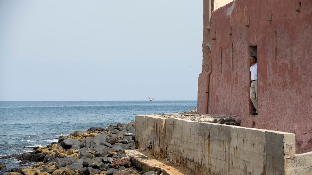 President Barack Obama looks out of the "door of no return" during a tour of Goree Island, Thursday, June 27, 2013, in Goree Island, Senegal. Goree Island is the site of the former slave house and embarkation point built by the Dutch in 1776, from...
