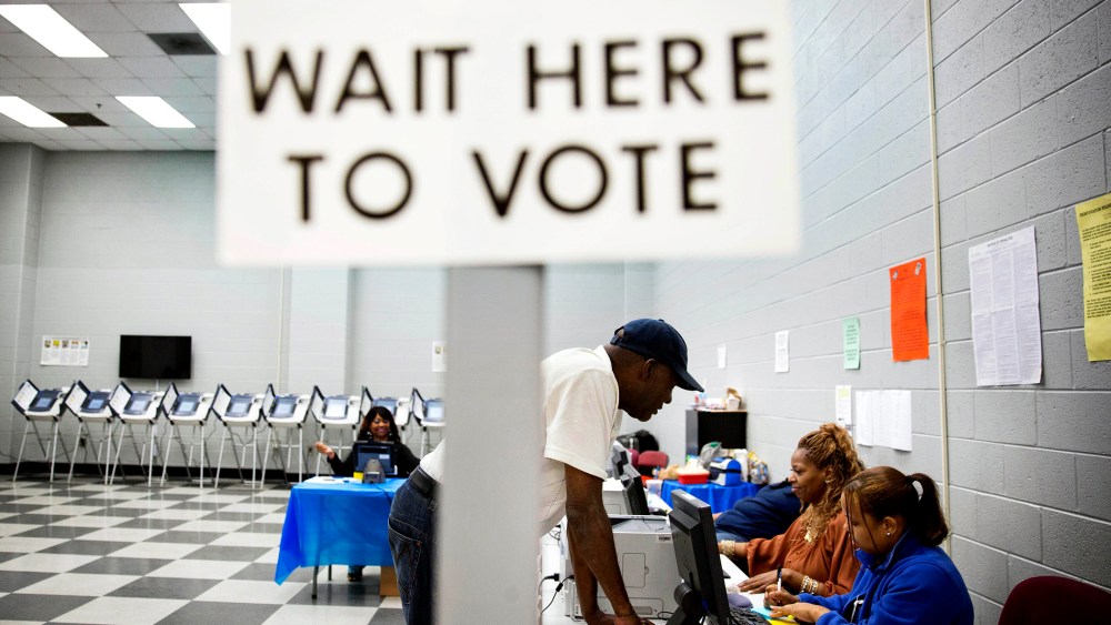 Charles Poole, 70, checks in upon arriving to cast his ballot at a polling site during early voting in Atlanta, Ga. on May 16, 2014.