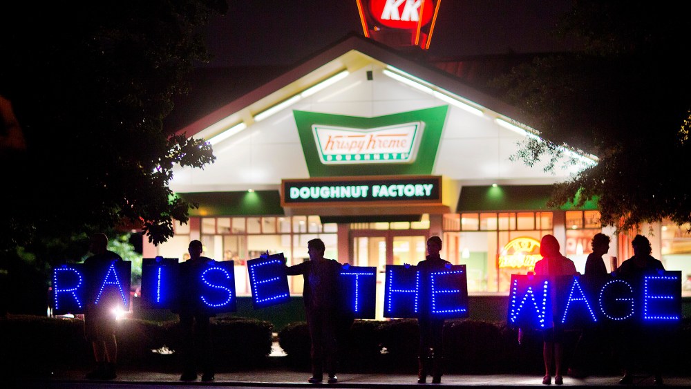 Fast food workers and supporters protest low wages outside a Krispy Kreme store, May 15, 2014, in Atlanta, Ga. (Photo by David Goldman/AP)