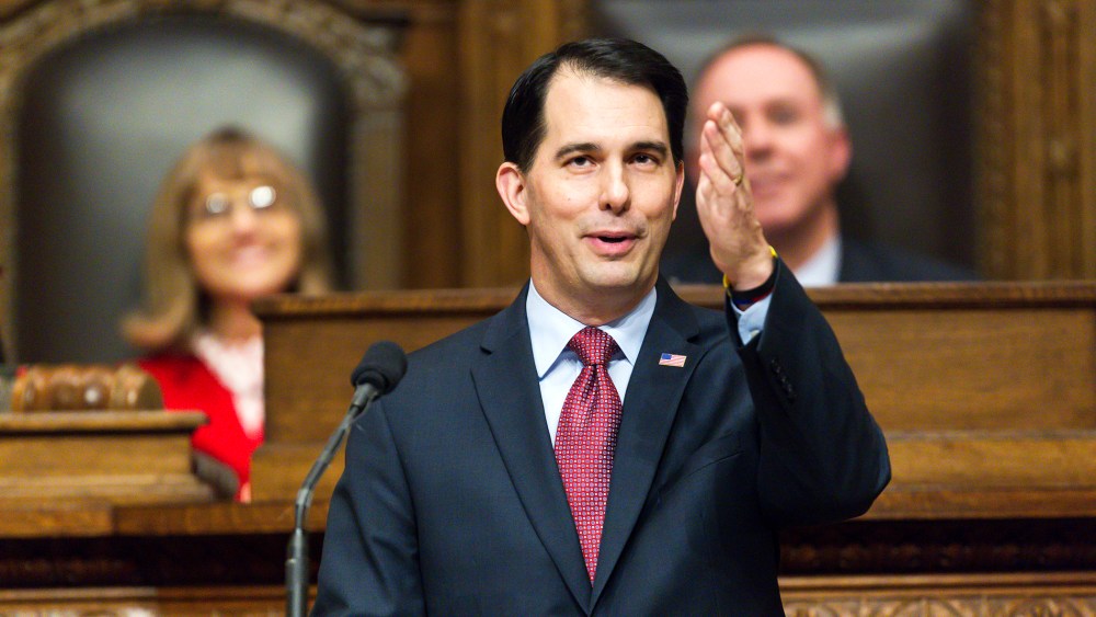 Wisconsin Gov. Scott Walker acknowledges people in the gallery during Governor's State of the State address to a joint session of the Legislature in the Assembly chambers at the state Capitol, Jan. 13, 2015, in Madison, Wis. (Photo by Andy Manis/AP)