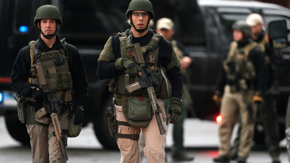 A Connecticut State Police tactical team searches a train station near an elementary school, which was in a lockdown, in Ridgefield, Conn. on Dec. 17, 2012 following the shooting at Sandy Hook Elementary School in Newtown.
