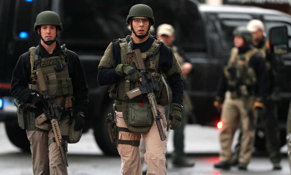 A Connecticut State Police tactical team searches a train station near an elementary school, which was in a lockdown, in Ridgefield, Conn. on Dec. 17, 2012 following the shooting at Sandy Hook Elementary School in Newtown.
