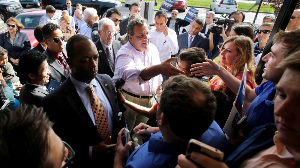New Jersey Gov. Chris Christie, center, reaches to shake a hand as he greets supporters during a campaign stop in Edison, N.J. on Tuesday, Oct. 8, 2013.