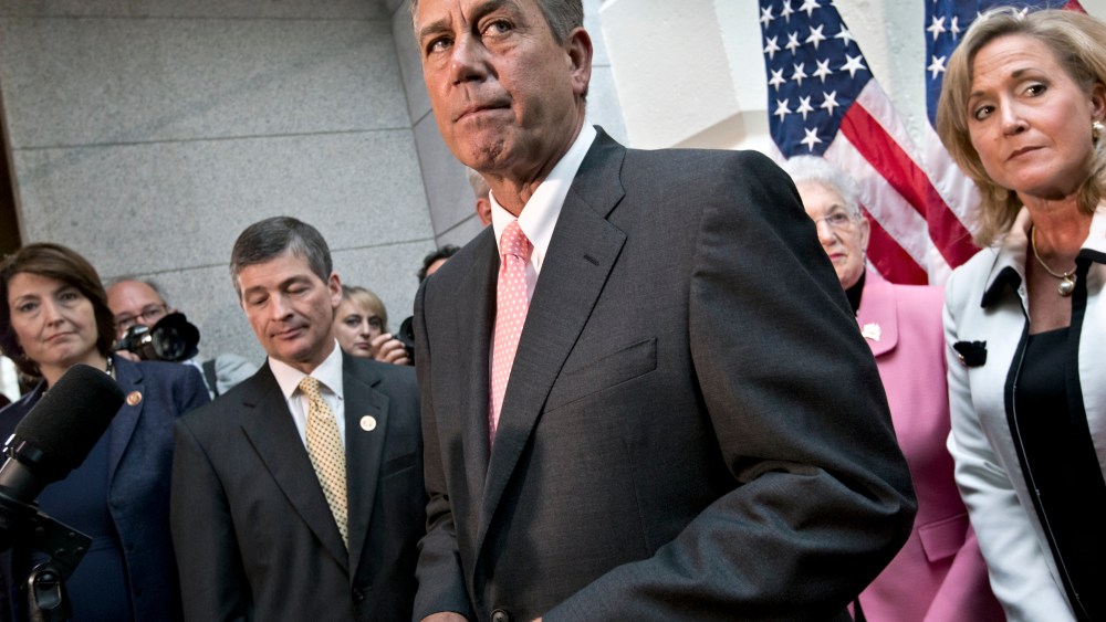 Speaker of the House John Boehner, R-Ohio, joined by fellow Republicans, emerges from a closed-door GOP meeting