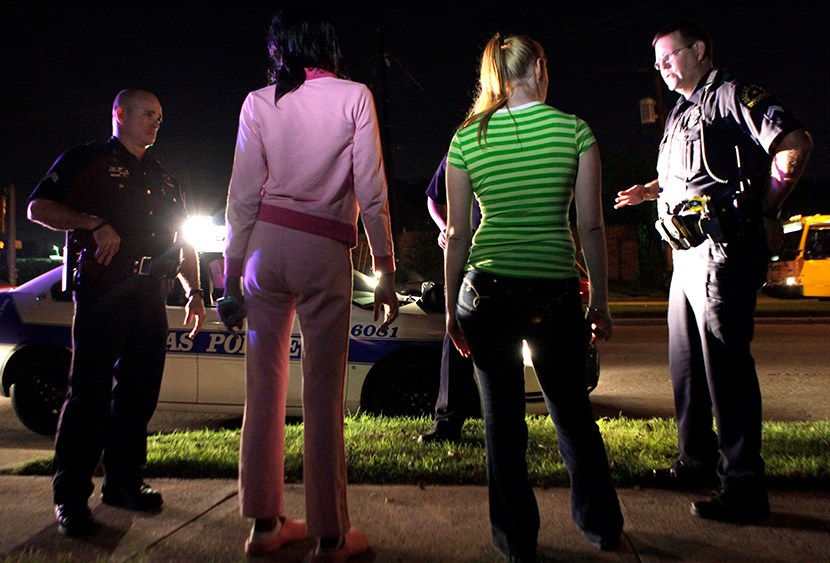 File Photo: In this Nov. 4, 2009 file photo, police talk to two young women before arresting them for prostitution in Dallas. The young woman second from left turned out to be underage at the time of her arrest. (Photo by LM Otero/AP)