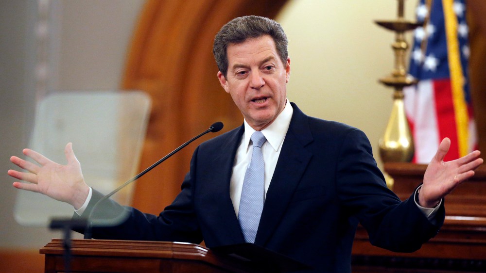 Kansas Gov. Sam Brownback delivers his State of the State speech to an annual joint session of the House and Senate at the Statehouse in Topeka, Kan., Jan. 15, 2014. (Photo by Orlin Wagner/AP)