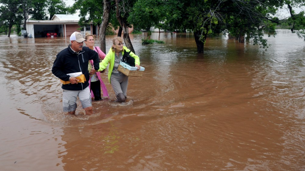 An elderly woman and her pets were rescued from her home on farm to market road 367, west of Wichita Falls, Texas, May 20, 2015. (Photo by Torin Halsey/Times Record News/AP)