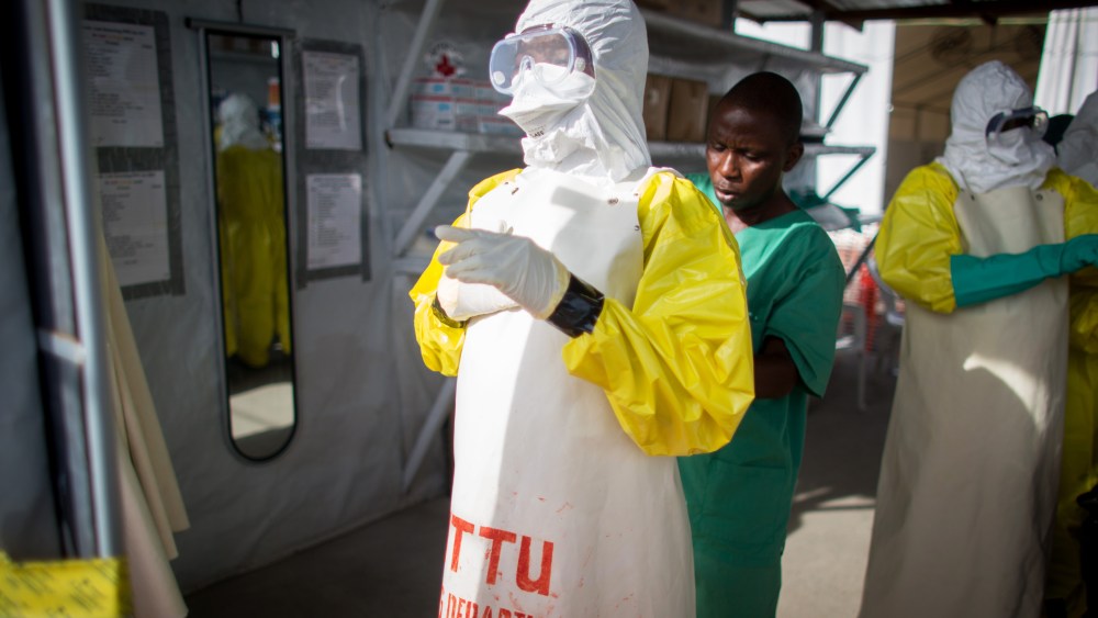 Volunteer Ebola helpers in protective suits prepare for a demonstration of their work at the SITTU (Severe Infections Temporary Treatment Unit) in Monrovia, Liberia, on April 9, 2015. (Photo by Kay Nietfeld/Picture Alliance/DPA/AP)