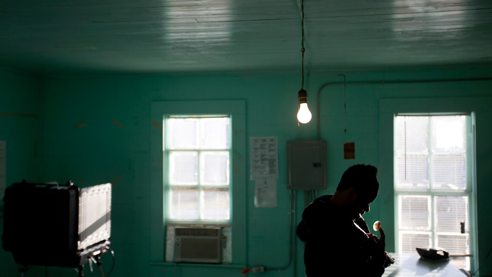 A poll manager places a "I Voted" sticker on her sweatshirt after taking her turn to cast her ballot inside the old Hoggards Mill Courthouse, now a polling site for Baker County, Nov. 4, 2014, in Newton, Ga. (Photo by David Goldman/AP)