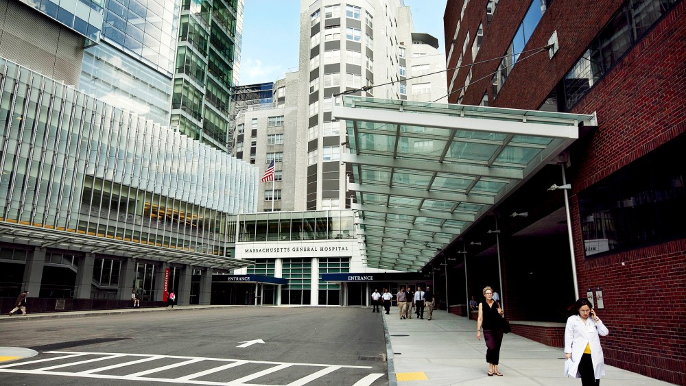 In this July 2, 2012 photo people walk near the entrance of Massachusetts General Hospital in Boston, Mass. (Photo by Steven Senne/AP)