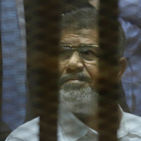 Egypt's ousted Islamist President Mohammed Morsi sits in a soundproof glass cage inside a makeshift courtroom at Egypt's national police academy in Cairo, Egypt, April 21, 2015. (Photo by Amr Nabil/AP)