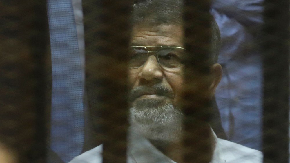 Egypt's ousted Islamist President Mohammed Morsi sits in a soundproof glass cage inside a makeshift courtroom at Egypt's national police academy in Cairo, Egypt, April 21, 2015. (Photo by Amr Nabil/AP)