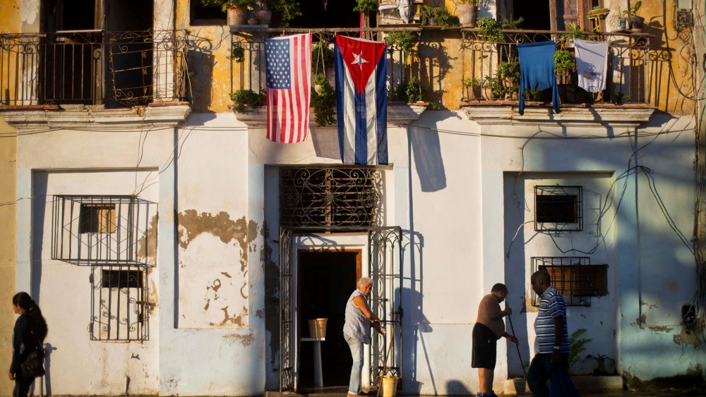 A U.S. and Cuban flag hang from the same balcony in Old Havana, Cuba, Dec. 19, 2014. (Photo by Ramon Espinosa/AP)