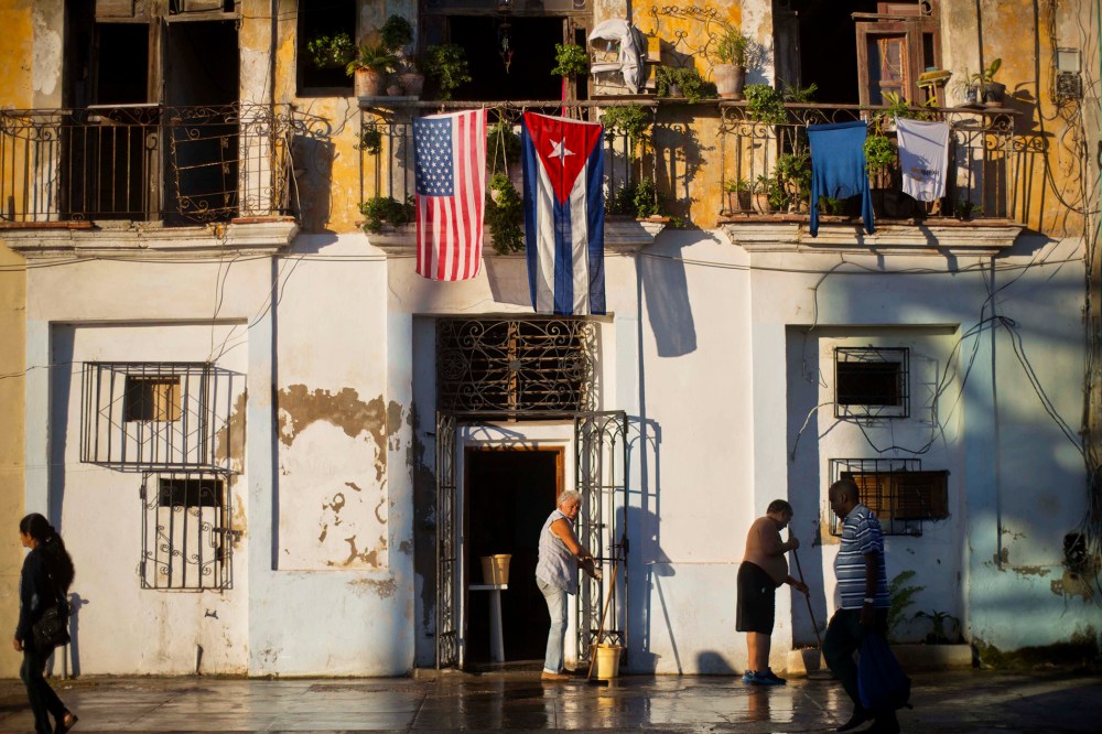 A U.S. and Cuban flag hang from the same balcony in Old Havana, Cuba, Dec. 19, 2014. (Photo by Ramon Espinosa/AP)