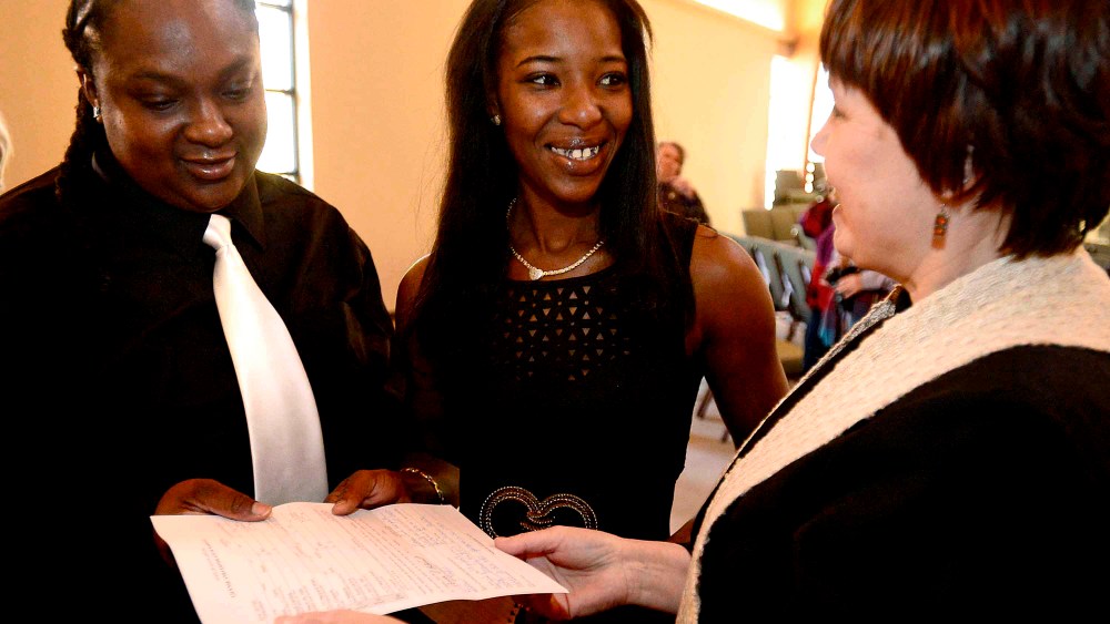 The Rev. Michelle Buhite hands Natasha Hemphill-Mayes and Leslie Mayes their marriage license after officiating the couples wedding ceremony on Nov. 23, 2014 in Spartanburg, SC. (Photo by Michael Justus/AP)
