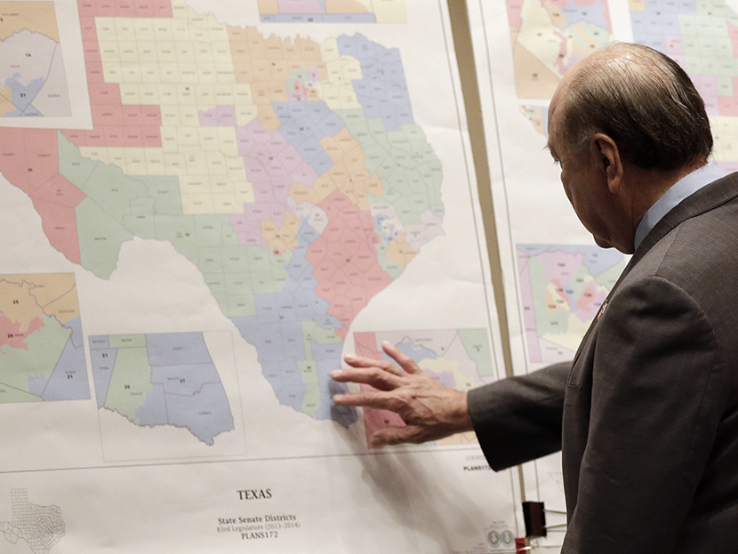 In this May 30, 2013 file photo, Texas state Sen. Juan "Chuy" Hinojosa looks at maps on display prior to a Senate Redistricting committee hearing, in Austin, Texas.  (Photo by Eric Gay/AP)