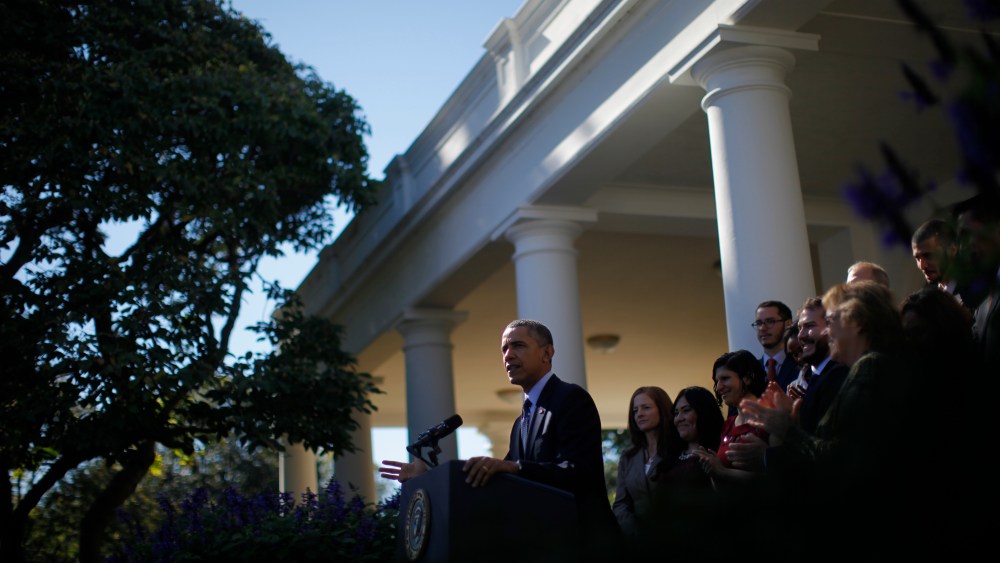 President Barack Obama stands with supporters of his health care law during an event in the Rose Garden of the White House