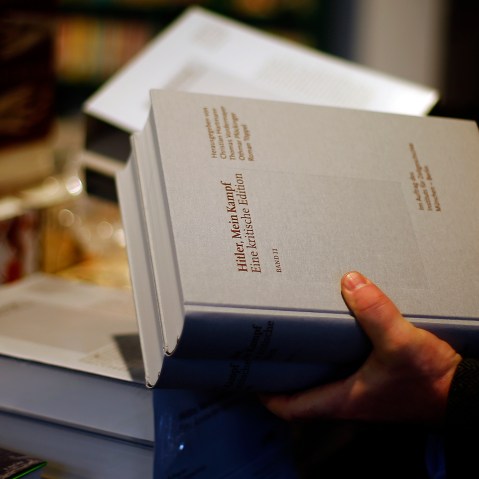 A books store clerk places the publication of "Hitler, Mein Kampf - A critical edition" in a book store in Munich, Germany, Jan. 8, 2016. (Photo by Matthias Schrader/AP)