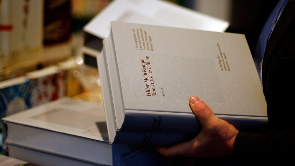 A books store clerk places the publication of "Hitler, Mein Kampf - A critical edition" in a book store in Munich, Germany, Jan. 8, 2016. (Photo by Matthias Schrader/AP)