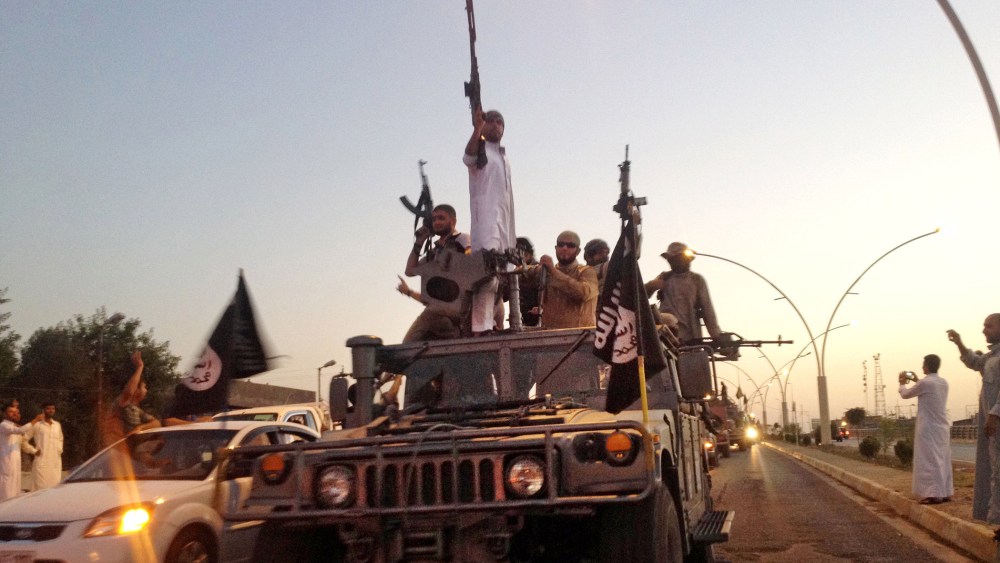 In this file photo taken on June 23, 2014, fighters from the Islamic State group parade in a commandeered Iraqi security forces armored vehicle down a main road at the northern city of Mosul, Iraq.  (AP)