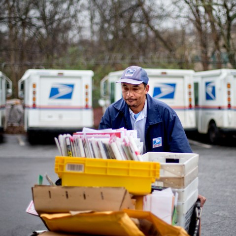 U.S. Postal Service letter carrier of 19 years, Michael McDonald, gathers mail to load into his truck before making his delivery run in the East Atlanta neighborhood, Thursday, Feb. 7, 2013, in Atlanta. The financially struggling U.S. Postal Service...