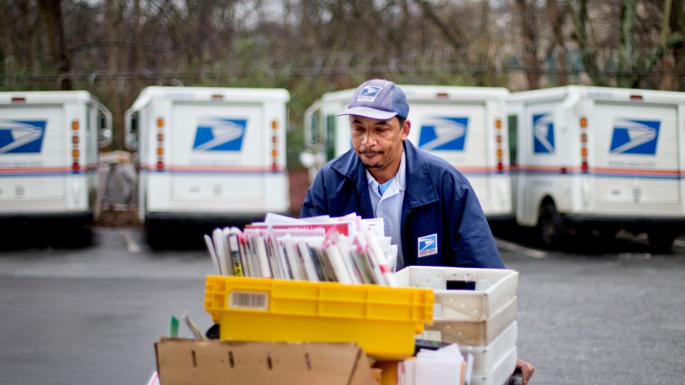 U.S. Postal Service letter carrier of 19 years, Michael McDonald, gathers mail to load into his truck before making his delivery run in the East Atlanta neighborhood, Thursday, Feb. 7, 2013, in Atlanta. The financially struggling U.S. Postal Service...