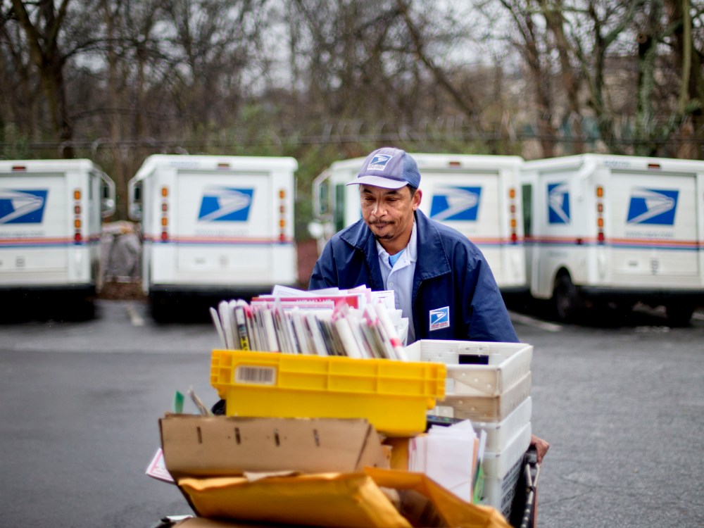 U.S. Postal Service letter carrier of 19 years, Michael McDonald, gathers mail to load into his truck before making his delivery run in the East Atlanta neighborhood, Thursday, Feb. 7, 2013, in Atlanta. The financially struggling U.S. Postal Service...