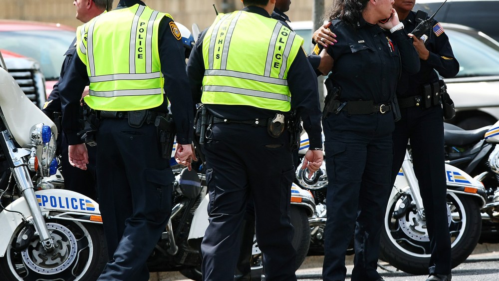 Memphis police officers work at the scene where an officer was shot in Memphis, Tenn., April 2, 2015. (Photo by Mike Brown/The Commercial Appeal/AP)