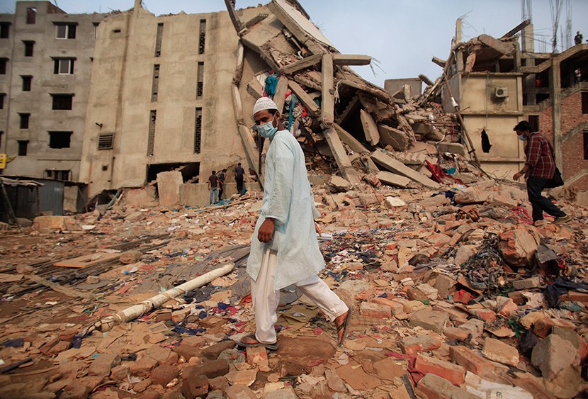 People make their way pass the garment factory building that collapsed Wednesday, in Savar, near Dhaka, Bangladesh, Saturday, April 27, 2013. (Photo by Wong Maye-E/AP)