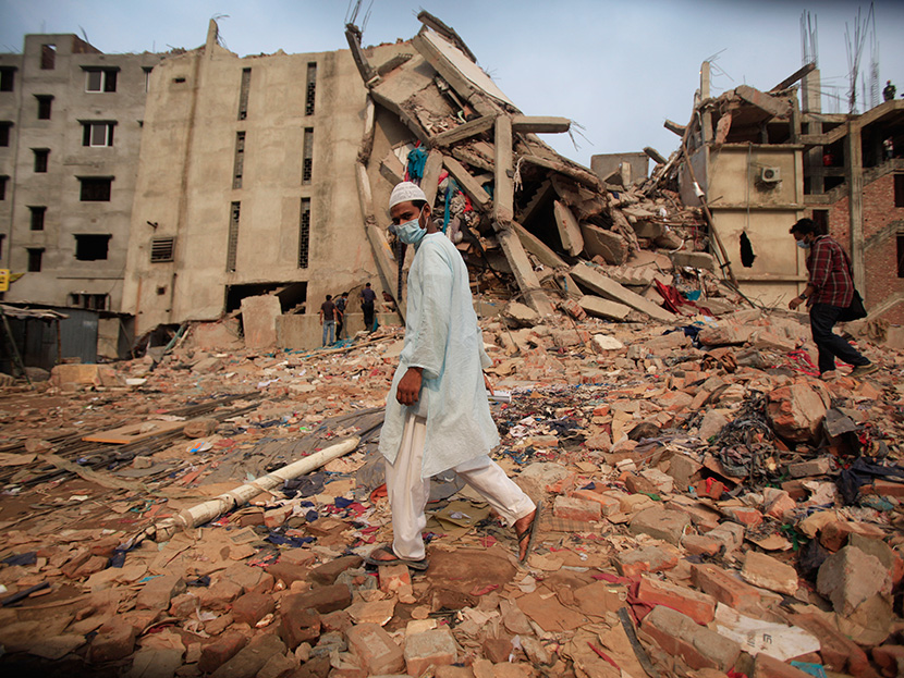 People make their way pass the garment factory building that collapsed Wednesday, in Savar, near Dhaka, Bangladesh, Saturday, April 27, 2013. (Photo by Wong Maye-E/AP)