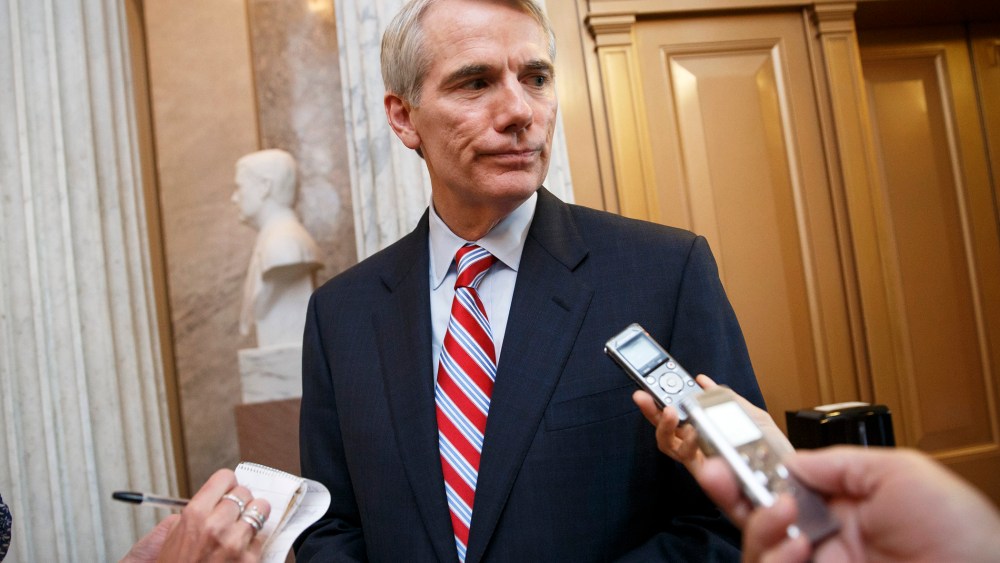 Sen. Rob Portman, R-Ohio, center, speaks with reporters in Washington, D.C., May 12, 2014. (Photo by AP)