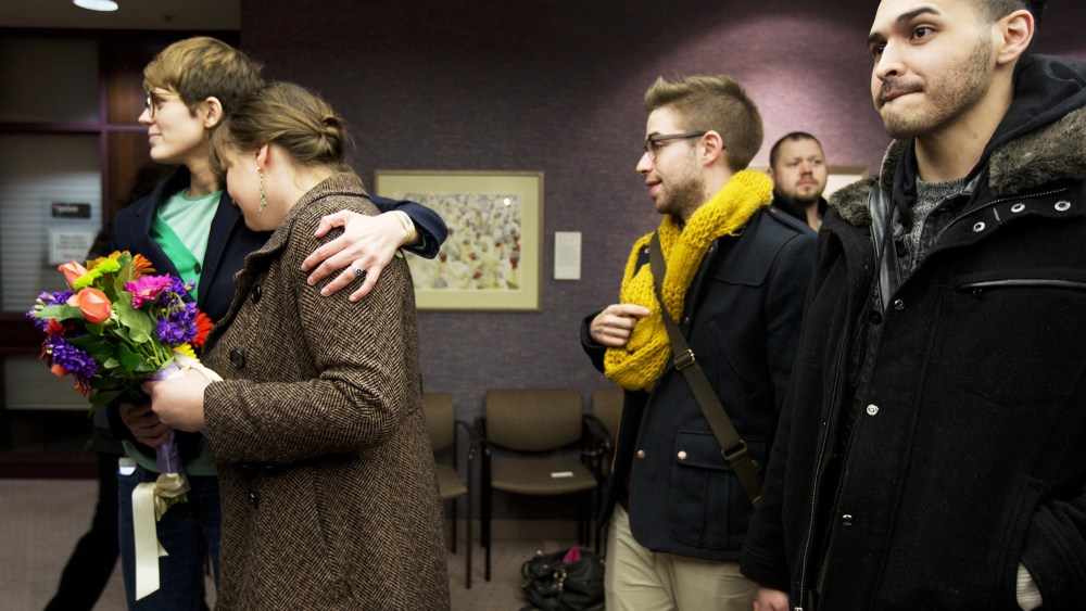 Same-sex couples wait in line to get a marriage license at the Salt Lake County Clerk's Office, Dec. 20, 2013.