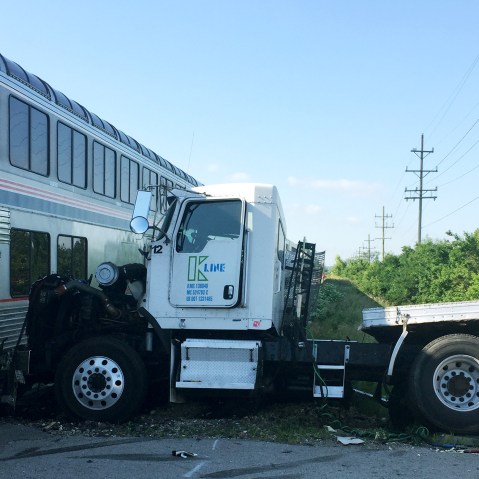 A train is stopped following a train collision near Wilmington, Ill., June 5, 2015. The Amtrak train was headed to Chicago from San Antonio and slammed into a semitrailer at a crossing. (Photo by Sam Herwitz/AP)